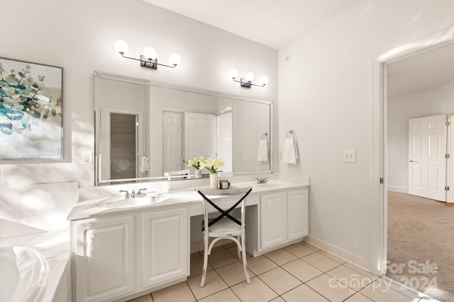 bathroom featuring vanity, a bathing tub, and tile patterned flooring