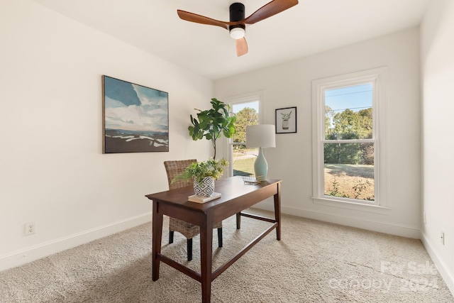 carpeted office space with ceiling fan