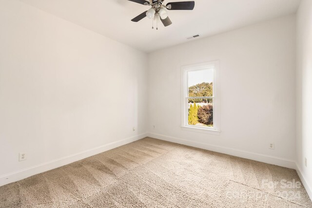 empty room featuring carpet flooring and ceiling fan