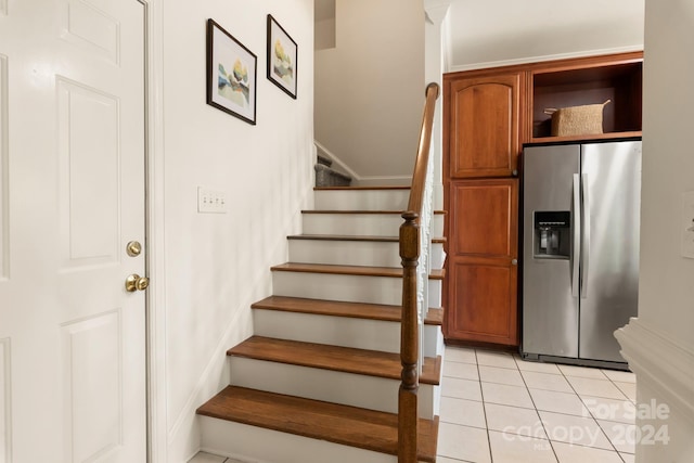 stairs featuring tile patterned flooring