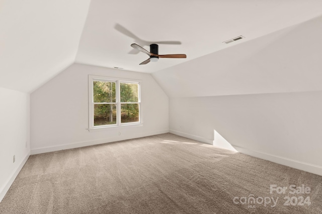 bonus room with lofted ceiling, carpet flooring, and ceiling fan