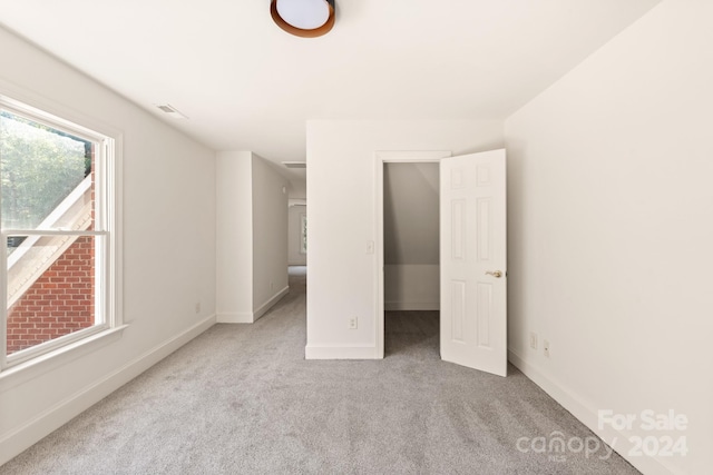 unfurnished bedroom with light carpet