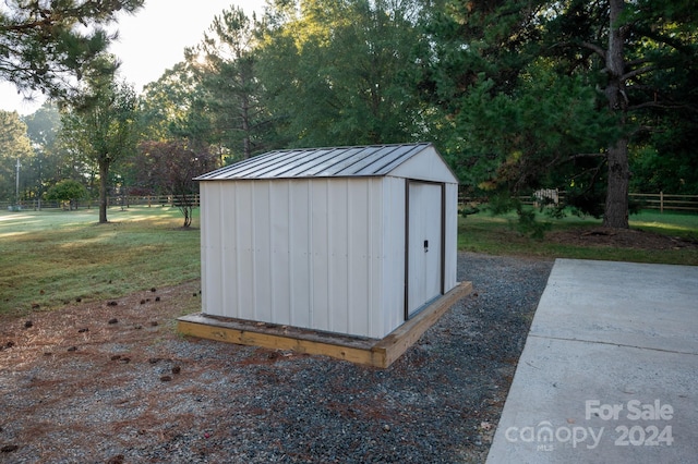 view of outdoor structure featuring a lawn