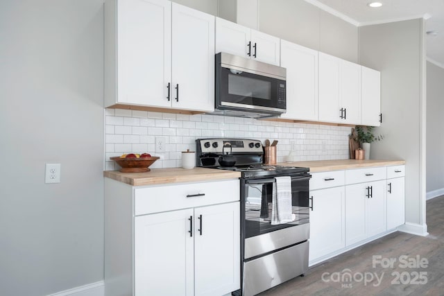 kitchen with stainless steel electric range, dark hardwood / wood-style floors, white cabinetry, and tasteful backsplash