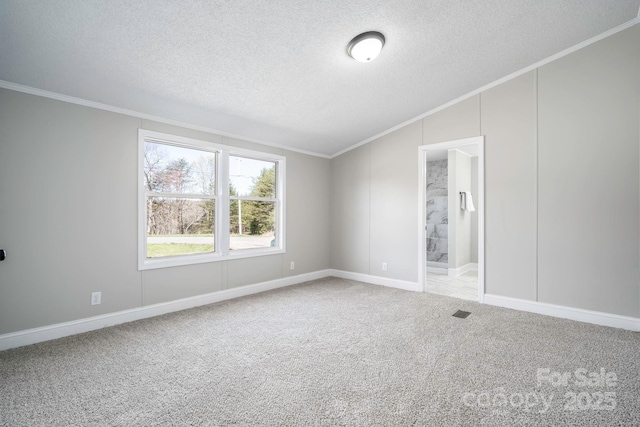 unfurnished room featuring carpet flooring, ornamental molding, a textured ceiling, and lofted ceiling