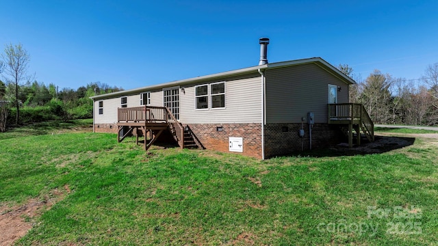 back of property with a yard and a deck