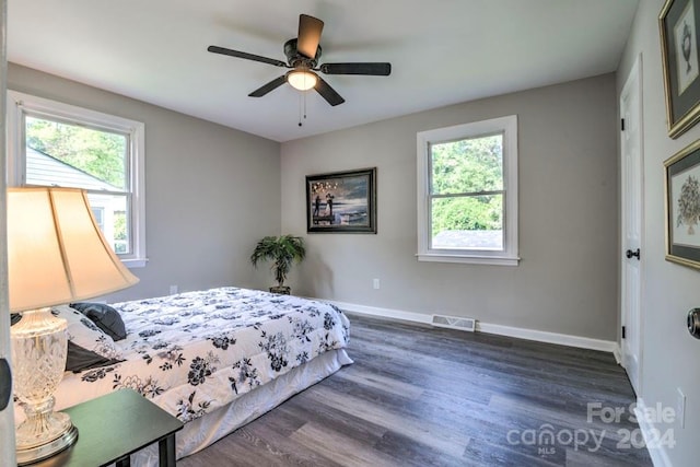 bedroom with ceiling fan and dark hardwood / wood-style floors