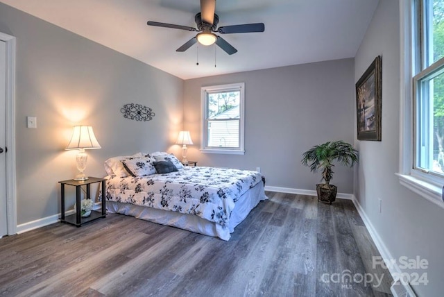 bedroom with dark wood-type flooring and ceiling fan