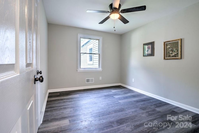 spare room featuring ceiling fan and dark hardwood / wood-style floors