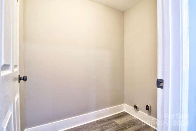 laundry area with wood-type flooring