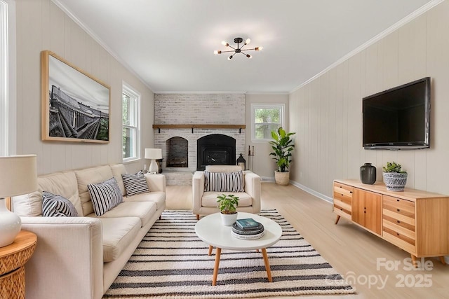 living room with ornamental molding, a wealth of natural light, and light wood-type flooring