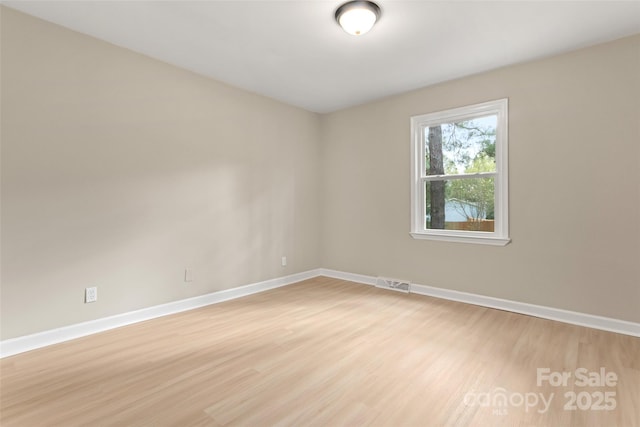 unfurnished room with light hardwood / wood-style floors