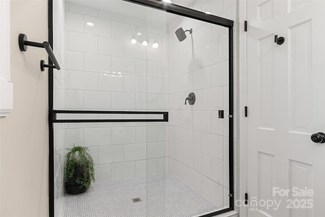 bathroom featuring a shower with door