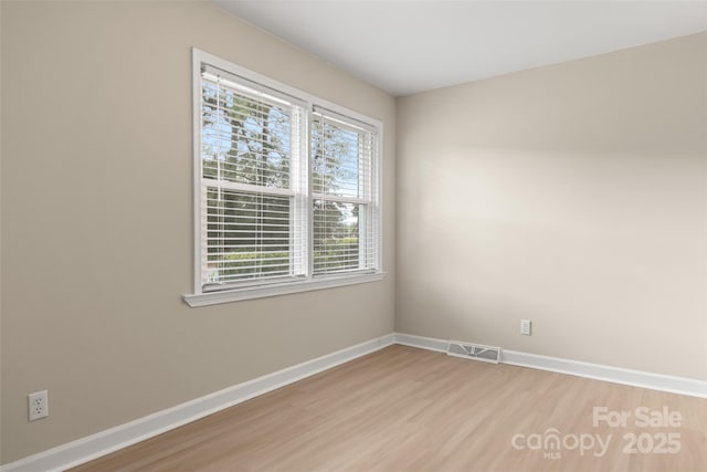 unfurnished room featuring light hardwood / wood-style flooring