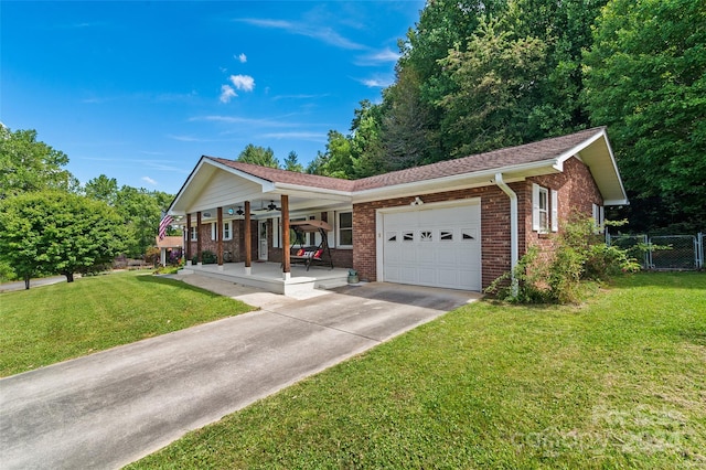 single story home with covered porch, a garage, and a front lawn