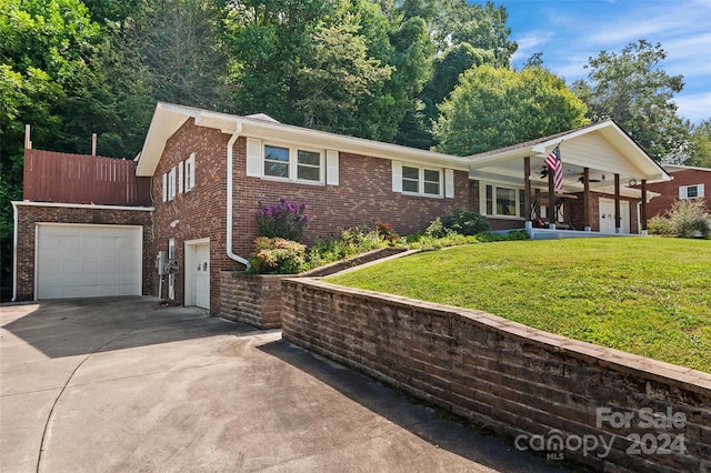 ranch-style home featuring a front lawn and a garage