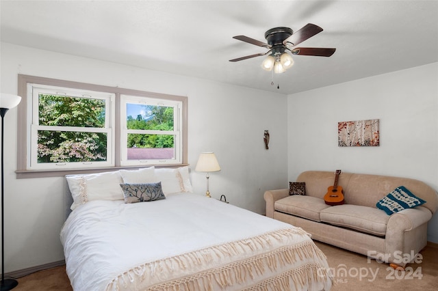 bedroom featuring multiple windows, ceiling fan, and carpet