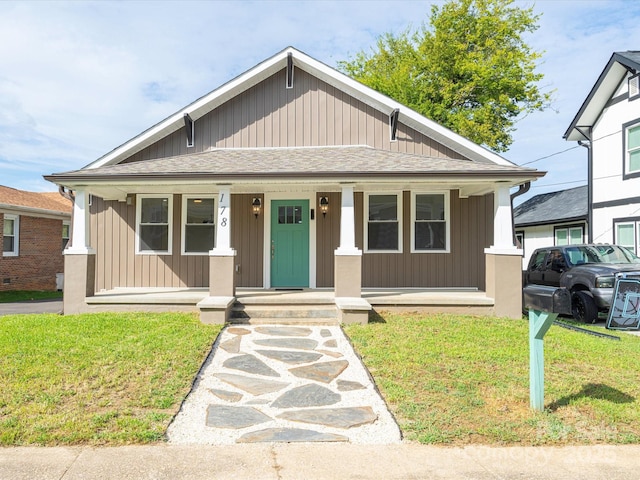 bungalow featuring a front lawn and a porch