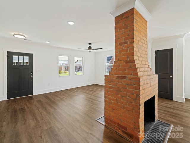 unfurnished living room featuring a brick fireplace, ceiling fan, hardwood / wood-style flooring, and ornamental molding