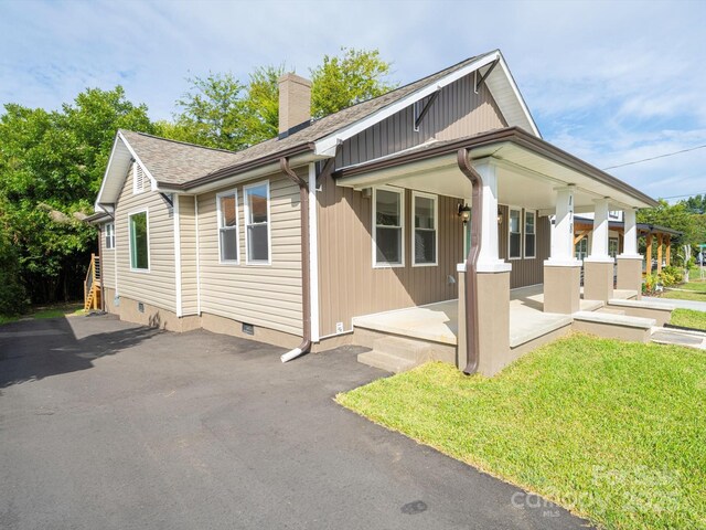 view of side of home with a porch