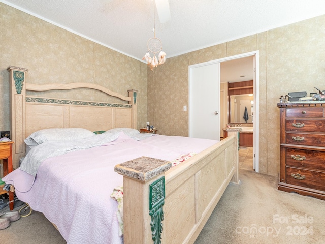 carpeted bedroom featuring ceiling fan and a textured ceiling