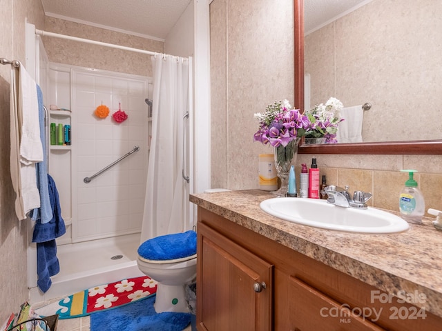 bathroom with a textured ceiling, toilet, vanity, and curtained shower