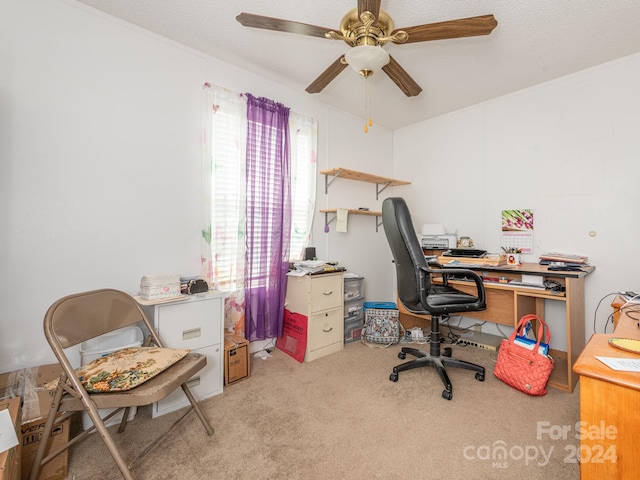 home office with a textured ceiling, light carpet, and ceiling fan