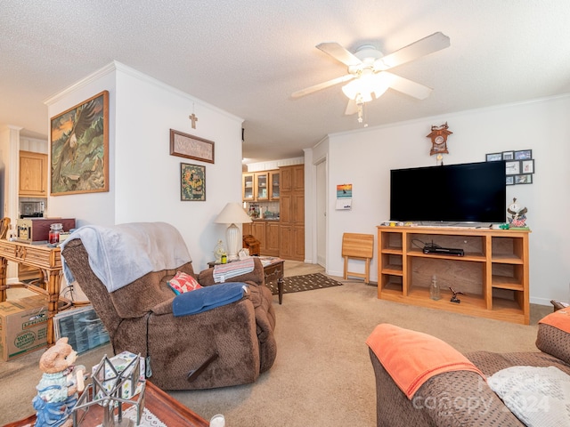 carpeted living room with ceiling fan, a textured ceiling, and ornamental molding