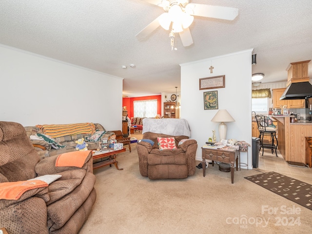 carpeted living room with a textured ceiling, ceiling fan, and a wealth of natural light