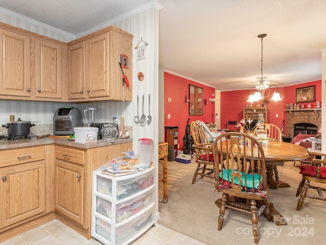 kitchen with hanging light fixtures, a fireplace, a textured ceiling, an inviting chandelier, and ornamental molding