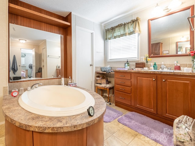 bathroom featuring tile patterned floors, a textured ceiling, and vanity