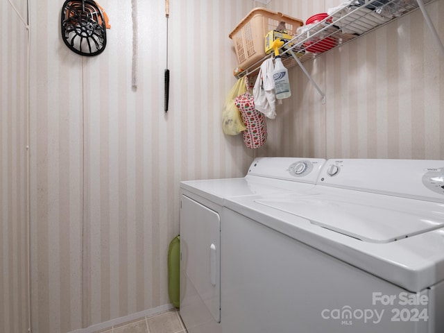 washroom with washing machine and clothes dryer and light tile patterned flooring