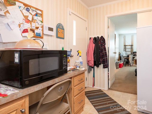 office area featuring light tile patterned flooring and crown molding