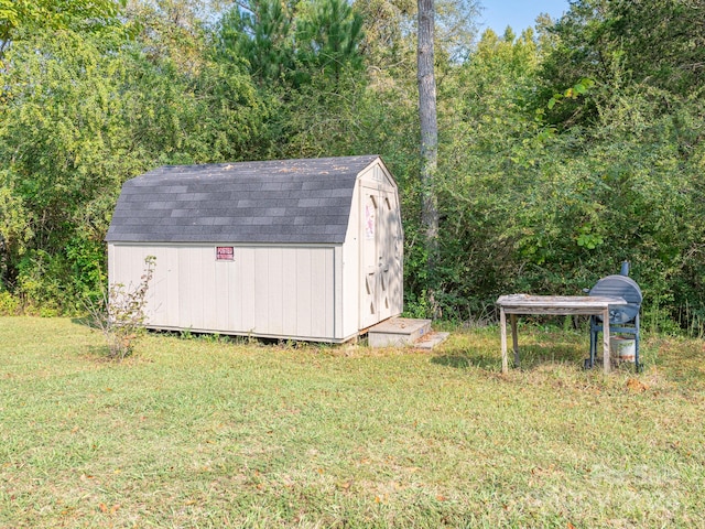 view of outbuilding featuring a lawn