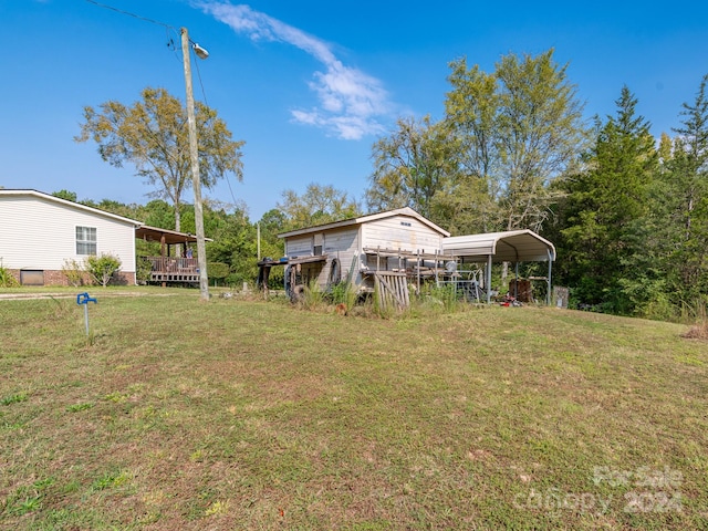 view of yard with a deck and a carport