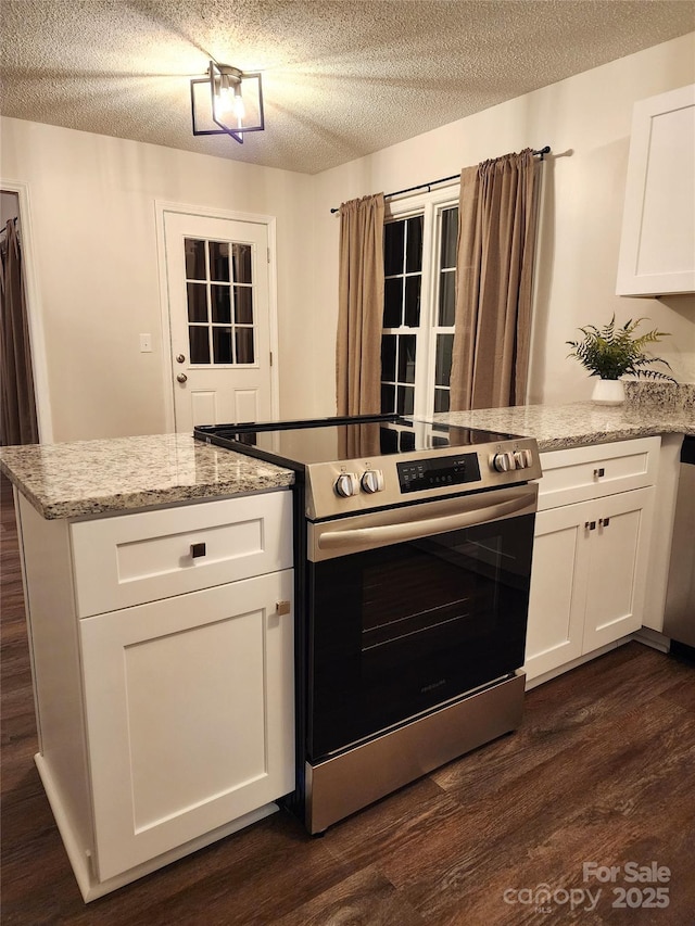 kitchen featuring light stone counters, stainless steel appliances, dark hardwood / wood-style floors, and white cabinets