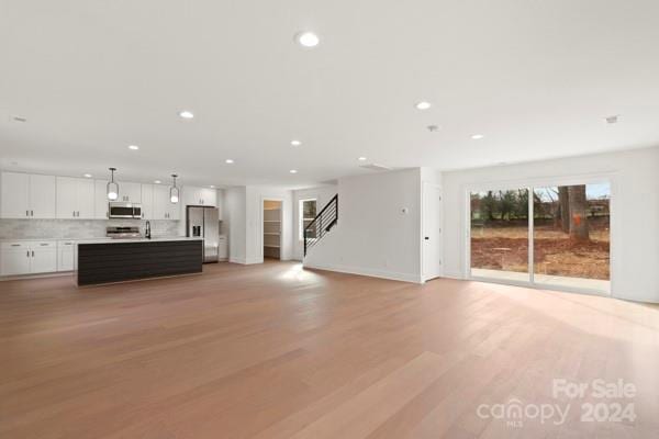 unfurnished living room featuring light hardwood / wood-style floors