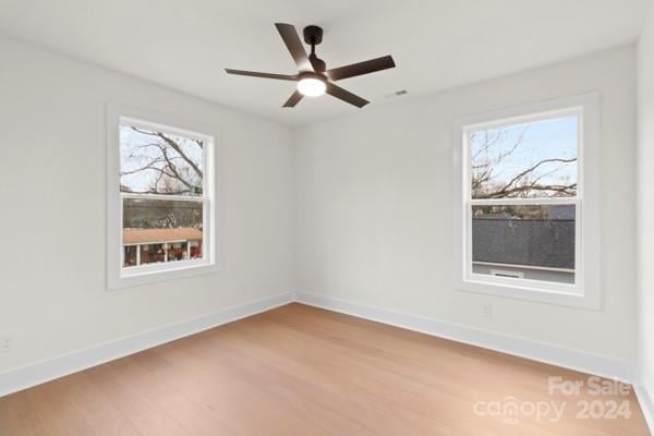 empty room featuring hardwood / wood-style floors and ceiling fan