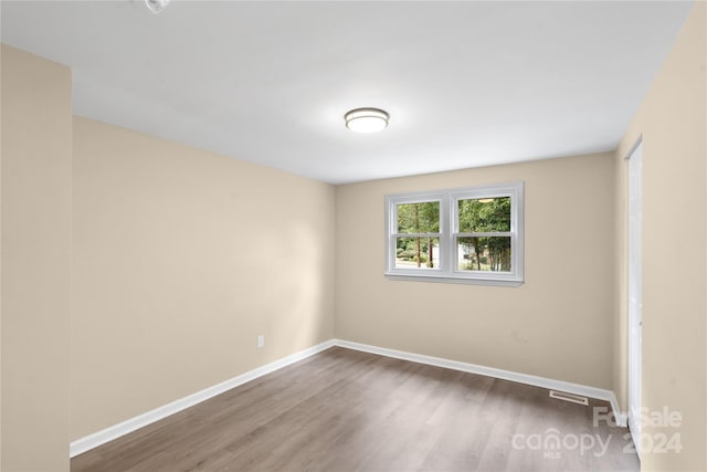 spare room featuring wood-type flooring