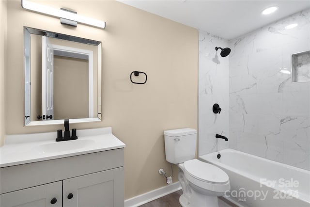 full bathroom with tiled shower / bath combo, vanity, toilet, and hardwood / wood-style floors