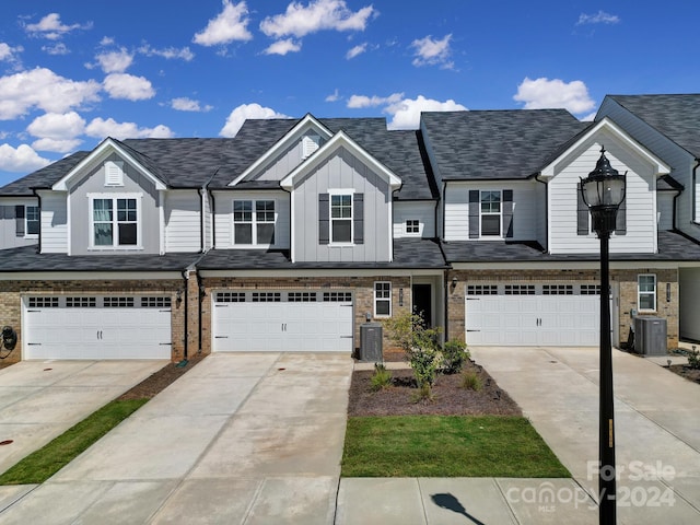 townhome / multi-family property featuring a garage and central AC unit