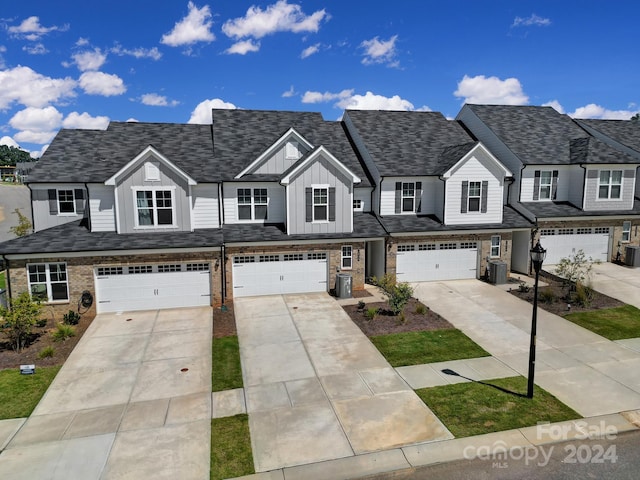 view of front of home featuring a garage and cooling unit