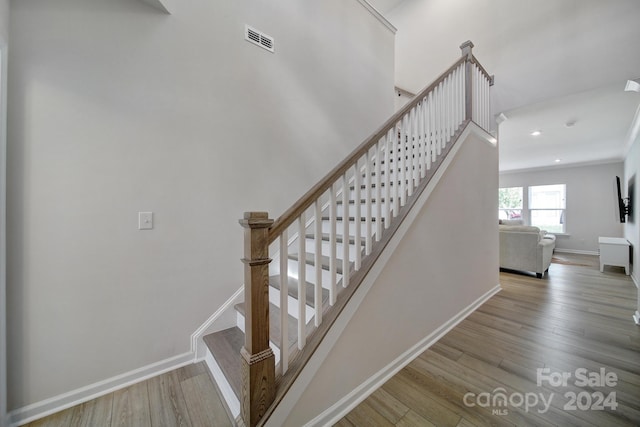 staircase with hardwood / wood-style flooring