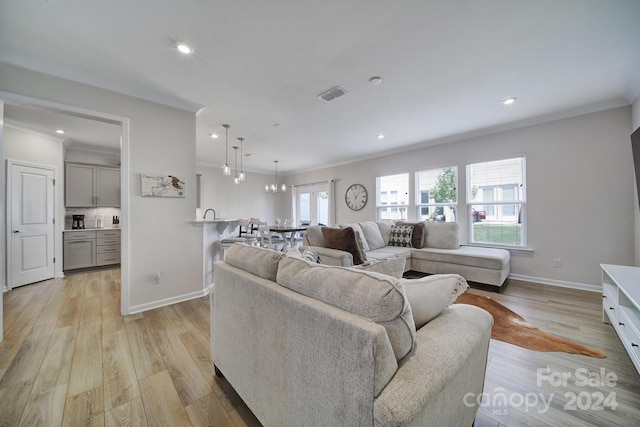 living room with crown molding and light hardwood / wood-style flooring