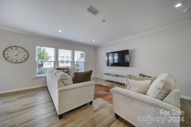 living room with ornamental molding and wood-type flooring