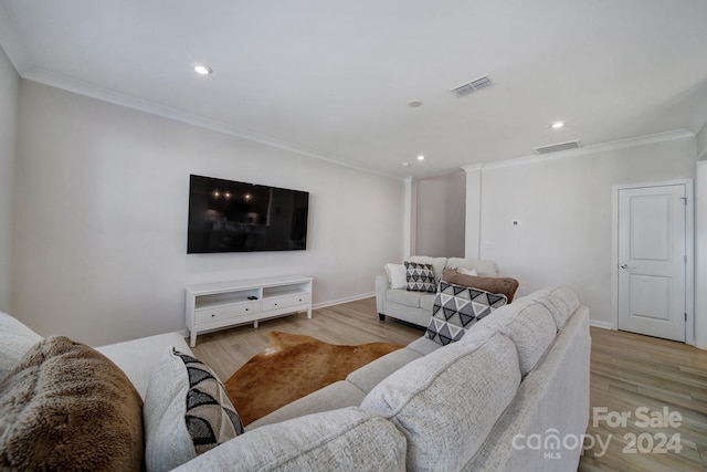 living room with ornamental molding and light hardwood / wood-style floors