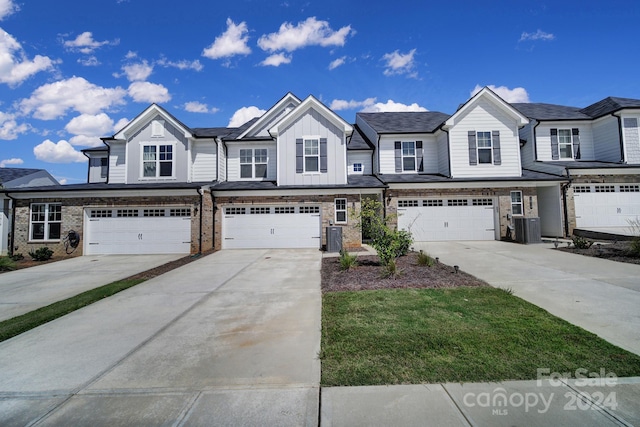 multi unit property featuring a garage and central air condition unit