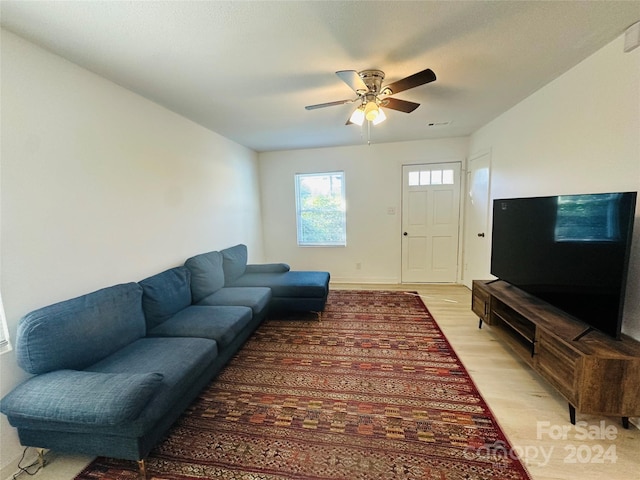 living room featuring ceiling fan and light hardwood / wood-style floors