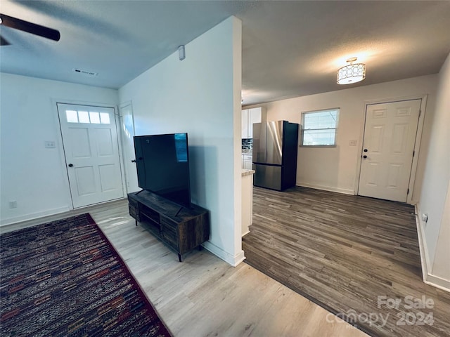 entryway featuring wood-type flooring, a textured ceiling, and ceiling fan