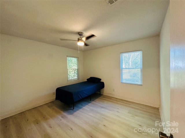 bedroom with wood-type flooring and ceiling fan